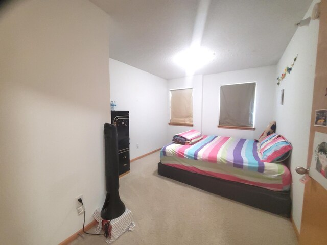 bedroom with carpet and baseboards