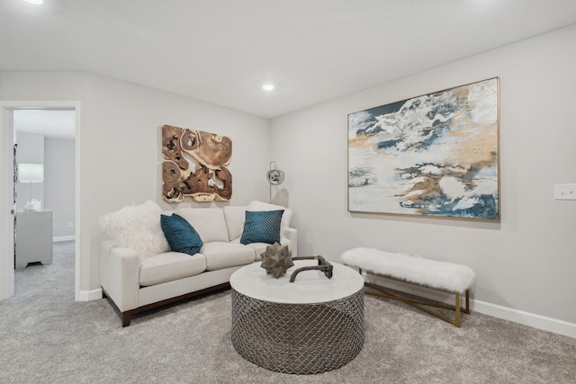 carpeted living area with recessed lighting and baseboards