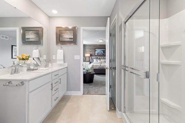 full bath featuring visible vents, double vanity, a sink, and a shower stall