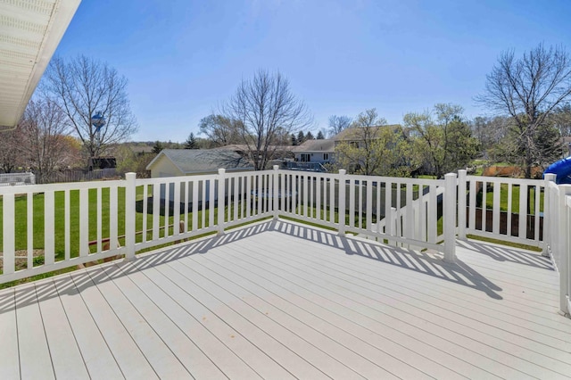 deck featuring a lawn and fence