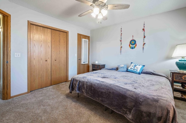 carpeted bedroom with ceiling fan and a closet