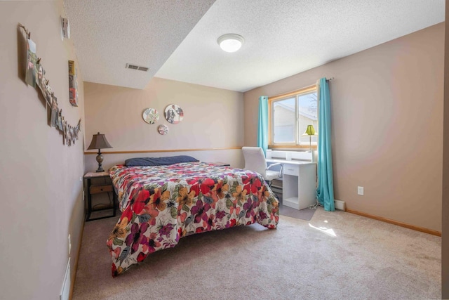 bedroom with visible vents, a textured ceiling, carpet, and baseboards