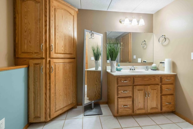 bathroom with vanity, baseboards, and tile patterned floors