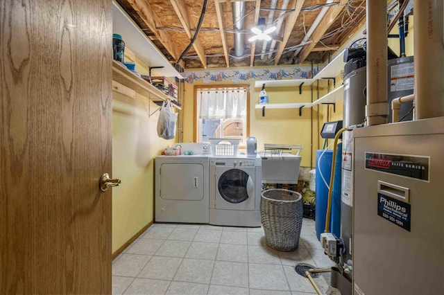 laundry area featuring laundry area, a sink, tile patterned flooring, heating unit, and washing machine and dryer