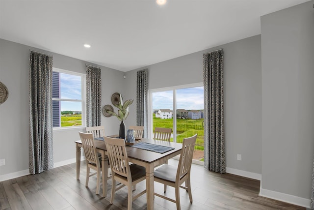 dining space with baseboards, recessed lighting, and wood finished floors