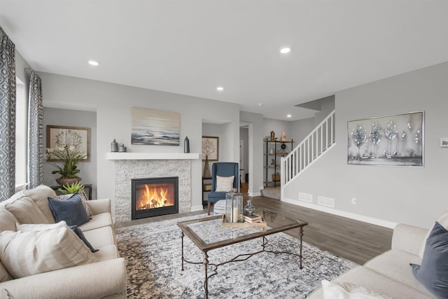 living area featuring recessed lighting, a fireplace, stairs, baseboards, and wood finished floors