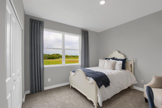 bedroom featuring a closet, carpet floors, and baseboards