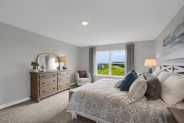 carpeted bedroom featuring baseboards and recessed lighting