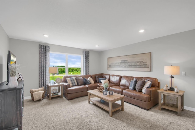 living room with recessed lighting, light colored carpet, and baseboards