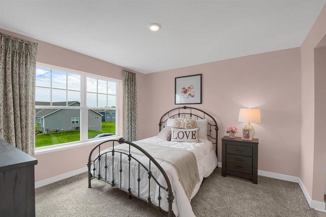 carpeted bedroom with baseboards