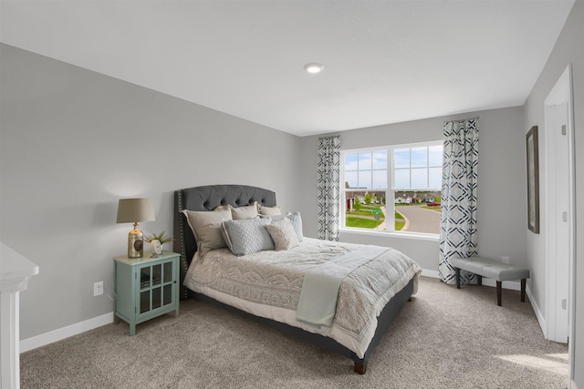carpeted bedroom featuring baseboards