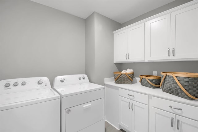laundry room with separate washer and dryer and cabinet space