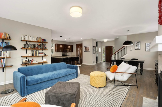 living area with dark wood finished floors, stairway, recessed lighting, and baseboards