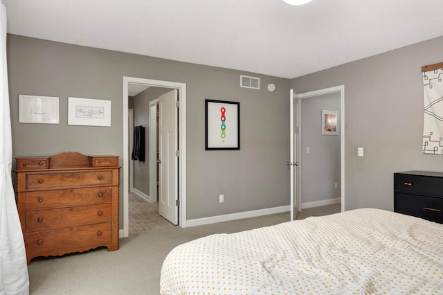 bedroom with baseboards, visible vents, and light carpet