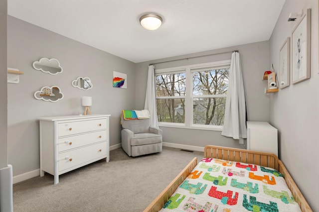 carpeted bedroom featuring visible vents and baseboards