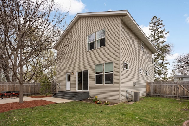 rear view of property featuring central AC, a yard, a patio, and a fenced backyard