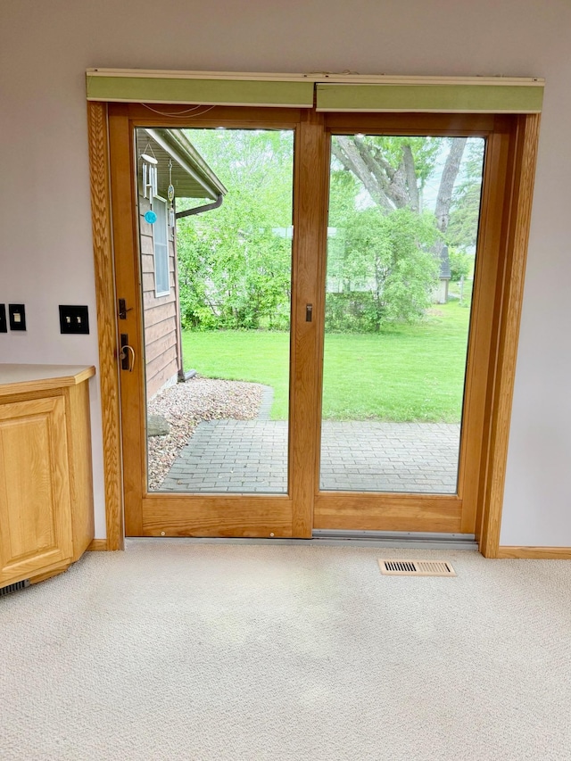 715 Crest Ln, Ellsworth, WI 54011 - doorway to outside featuring carpet and baseboards