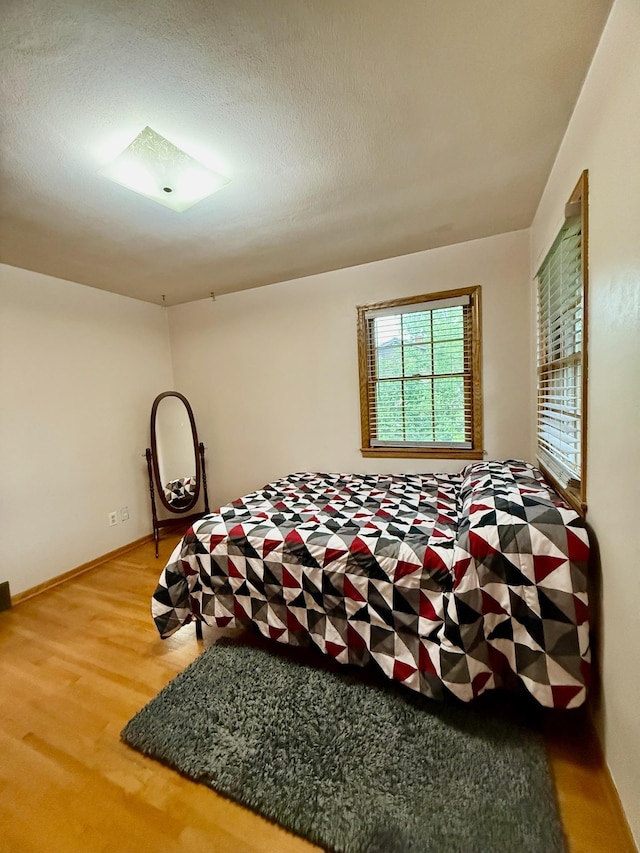 715 Crest Ln, Ellsworth, WI 54011 - bedroom featuring wood finished floors and baseboards