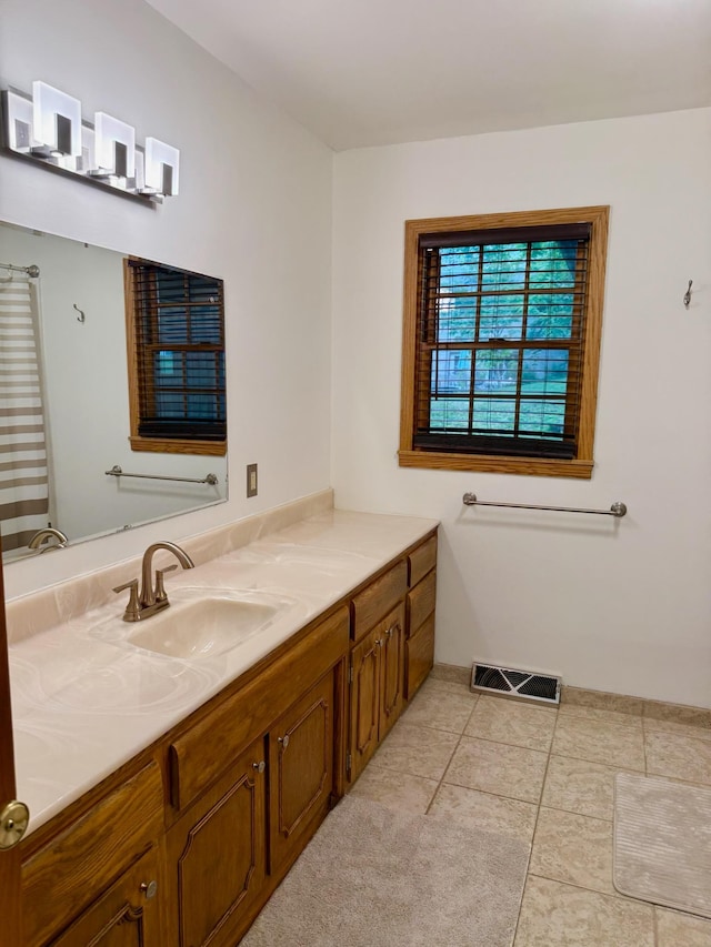 715 Crest Ln, Ellsworth, WI 54011 - full bath with vanity, tile patterned flooring, and baseboards