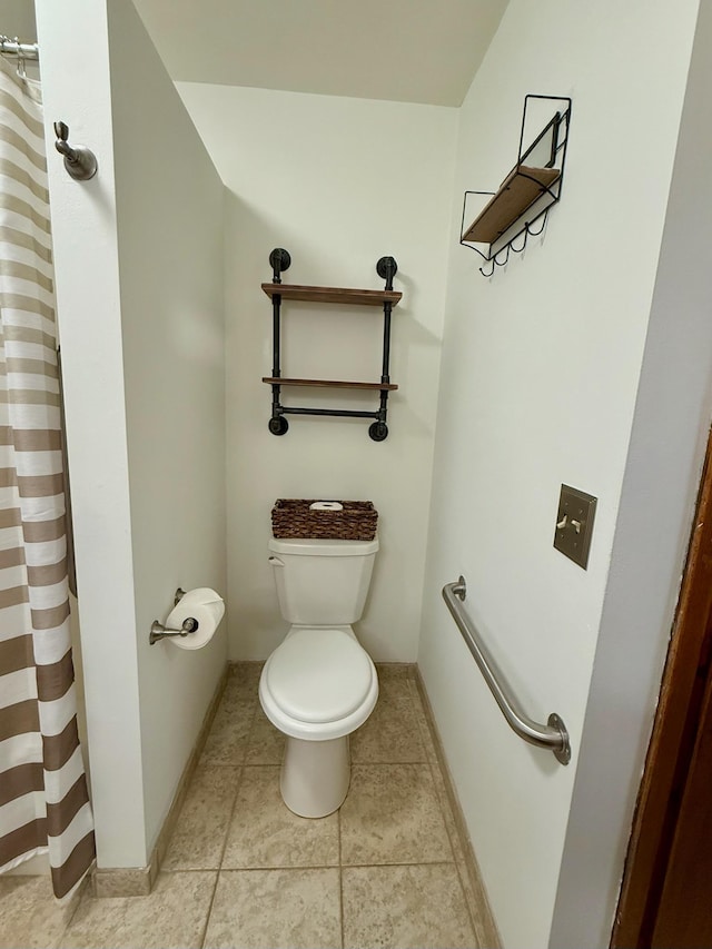 715 Crest Ln, Ellsworth, WI 54011 - bathroom with toilet, a shower with curtain, tile patterned flooring, and baseboards