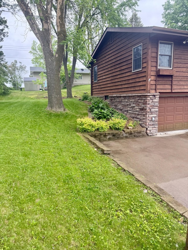 715 Crest Ln, Ellsworth, WI 54011 - view of side of property with an attached garage, a yard, and driveway