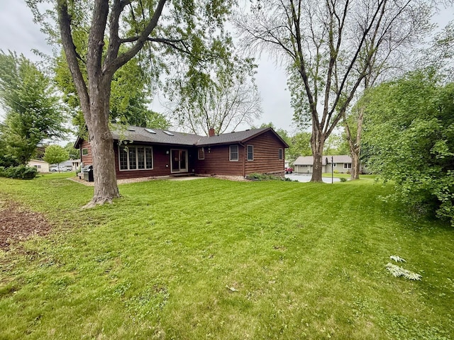 715 Crest Ln, Ellsworth, WI 54011 - rear view of property with a chimney and a lawn