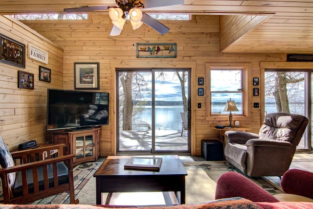 living room featuring wood walls, ceiling fan, and wooden ceiling