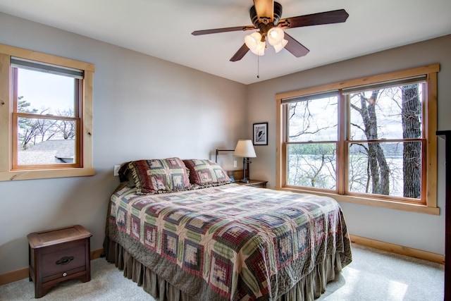 carpeted bedroom with baseboards and a ceiling fan