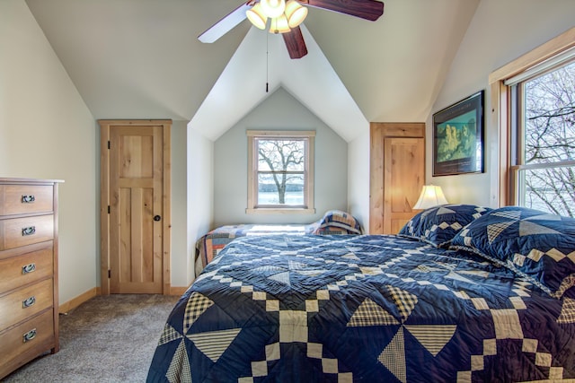 bedroom with lofted ceiling, multiple windows, carpet flooring, and ceiling fan