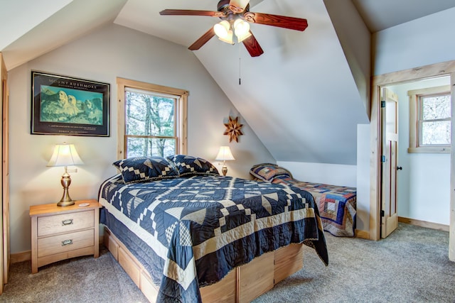 carpeted bedroom featuring vaulted ceiling and a ceiling fan