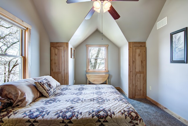 carpeted bedroom featuring vaulted ceiling, ceiling fan, baseboards, and visible vents