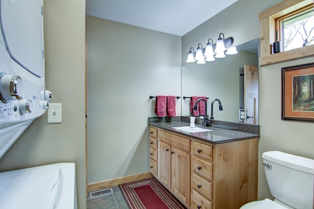 bathroom with toilet, baseboards, visible vents, tile patterned floors, and vanity