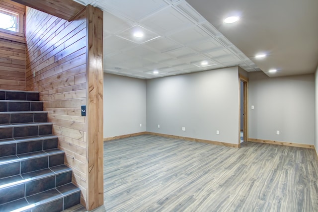 below grade area featuring wood finished floors, baseboards, and recessed lighting