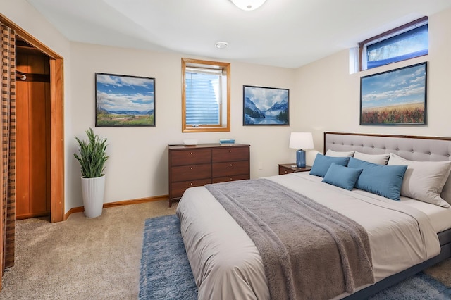 bedroom with light colored carpet and baseboards