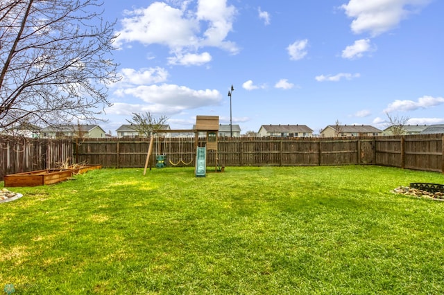 view of yard featuring a fenced backyard and a playground