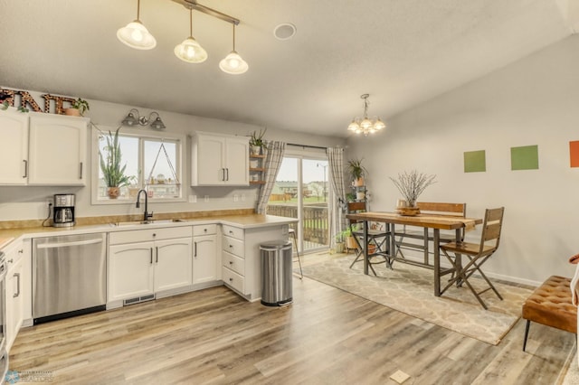 kitchen featuring a sink, white cabinets, stainless steel dishwasher, and light wood finished floors