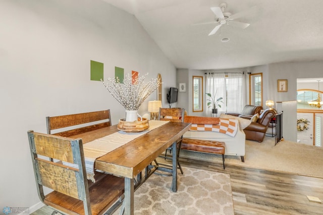 dining room featuring ceiling fan, wood finished floors, and lofted ceiling