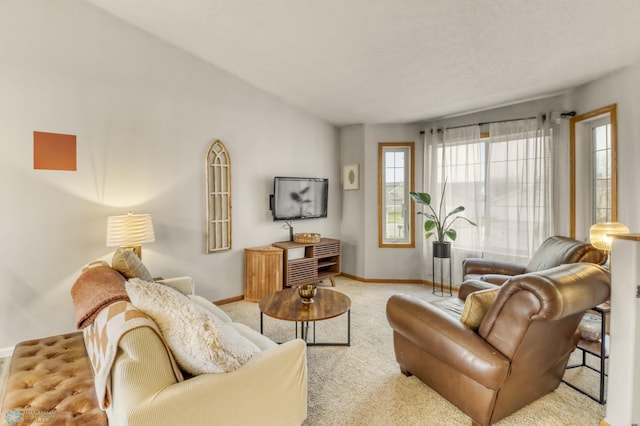 carpeted living room with baseboards