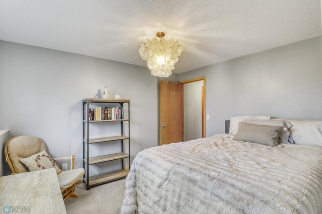 bedroom with carpet floors and an inviting chandelier