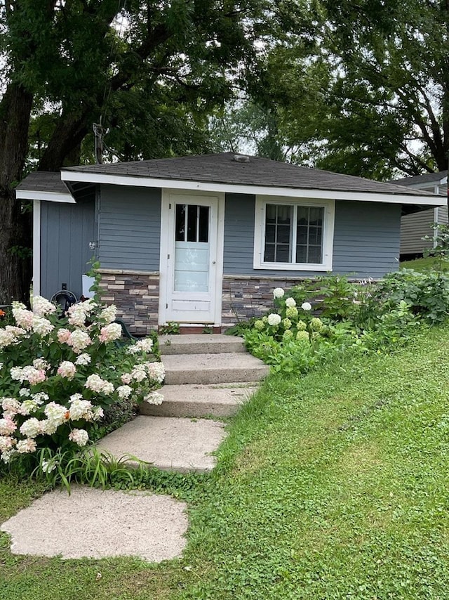 exterior space featuring stone siding