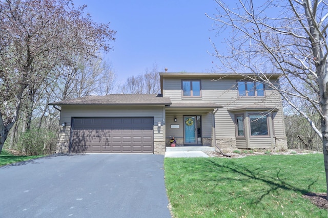 traditional-style house with brick siding, a garage, driveway, and a front yard