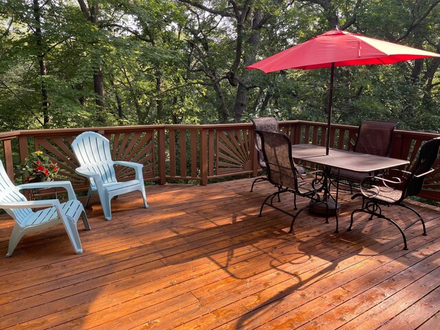 wooden terrace with outdoor dining space