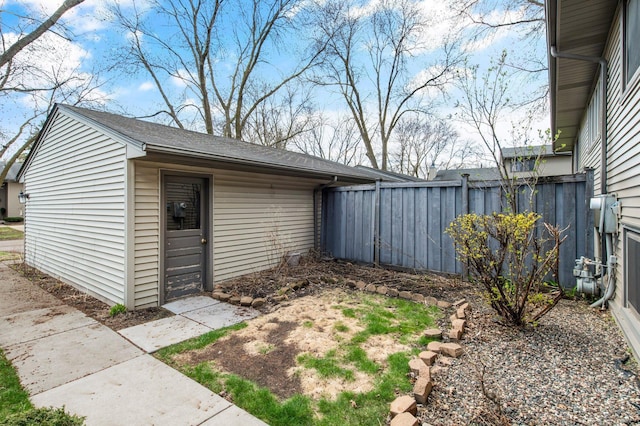 view of outbuilding featuring fence and an outdoor structure