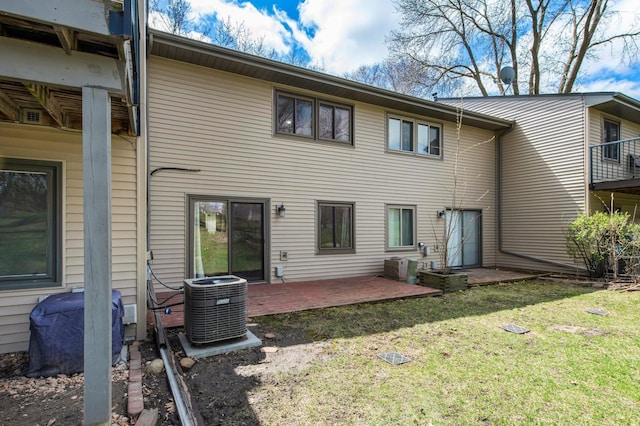 rear view of property with a yard, a patio area, and central AC unit