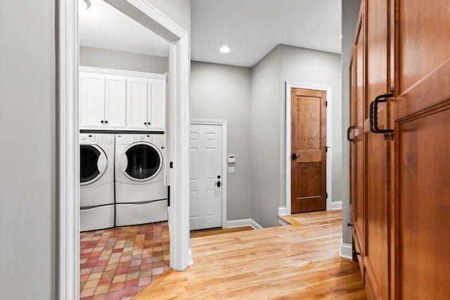 laundry area with light wood-style floors, baseboards, washing machine and dryer, and recessed lighting