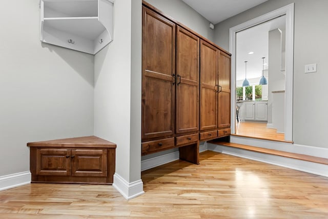 mudroom featuring light wood-style floors and baseboards