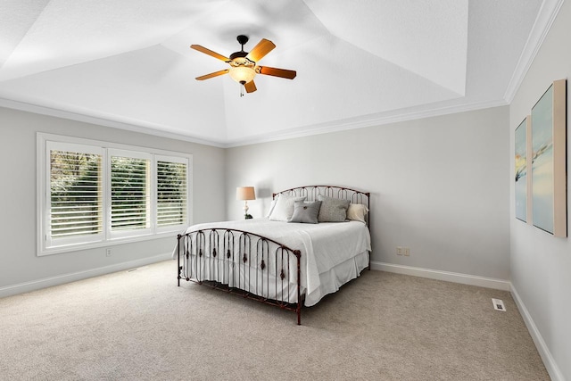bedroom with crown molding, visible vents, lofted ceiling, a ceiling fan, and carpet