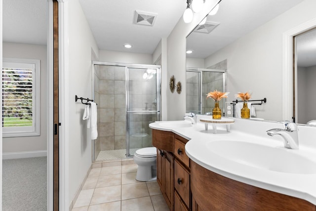 bathroom featuring visible vents, a sink, a stall shower, and toilet