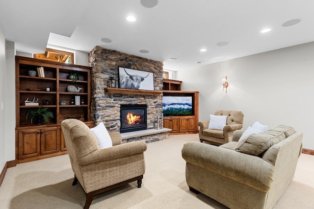 living area featuring recessed lighting, baseboards, a fireplace, and light carpet