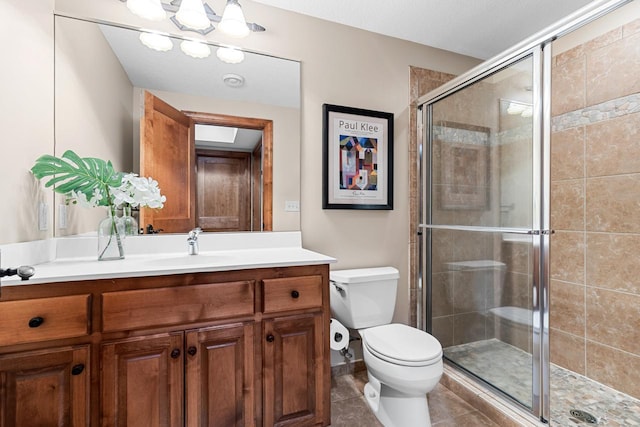 full bath featuring vanity, tile patterned floors, a stall shower, and toilet